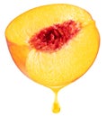 Slice of peach fruit and peach juice dripping from it on a white background. File includes clipping path Royalty Free Stock Photo